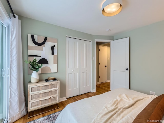 bedroom featuring light hardwood / wood-style flooring and a closet