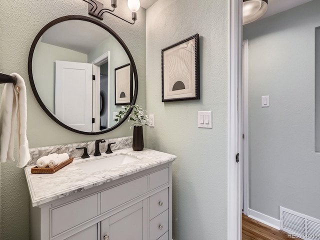 bathroom with wood-type flooring and vanity