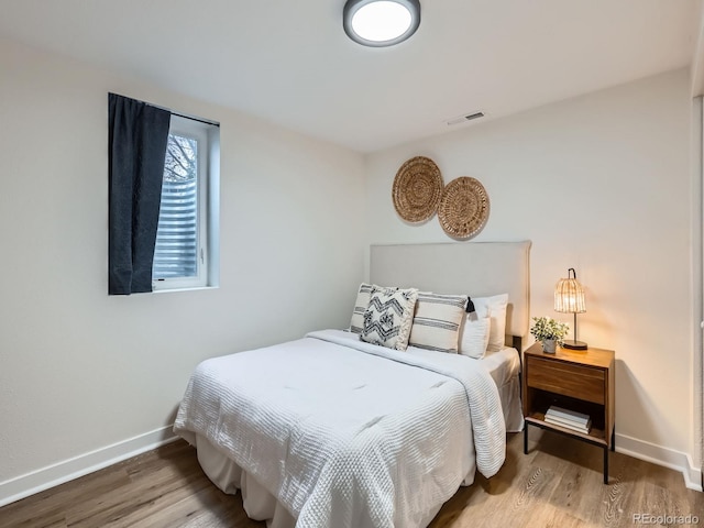 bedroom with hardwood / wood-style floors