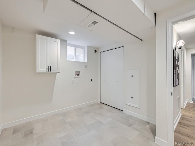 clothes washing area featuring baseboards, cabinet space, hookup for a washing machine, and visible vents