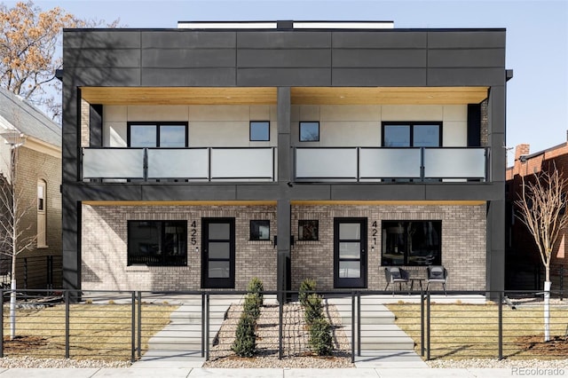 view of building exterior featuring a fenced front yard