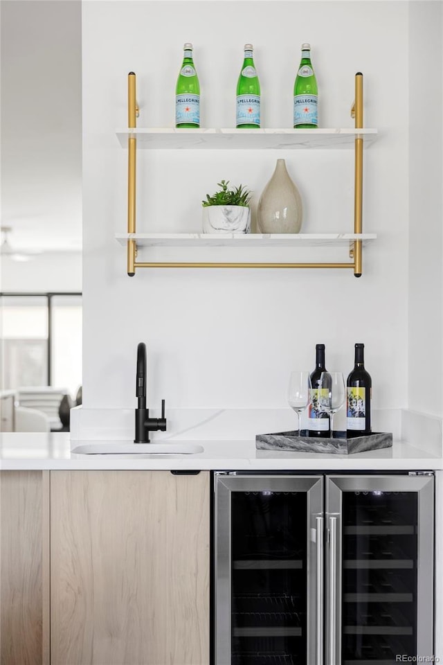 bar with a sink, wine cooler, and a dry bar