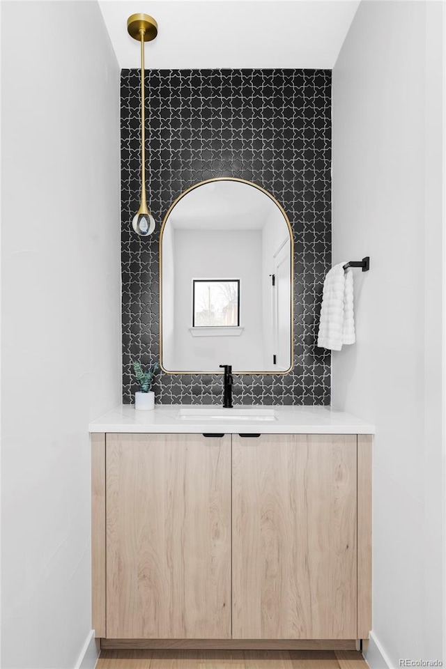 bathroom with vanity and baseboards