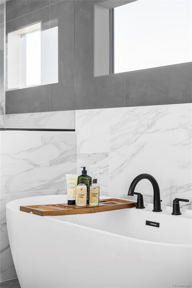 bathroom featuring a freestanding bath and a sink