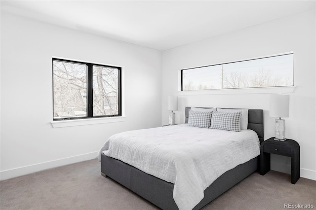 carpeted bedroom featuring baseboards