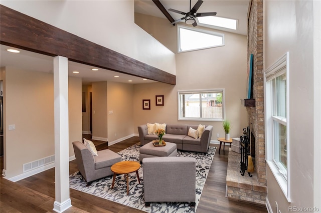 8160 W Phillips Ave, Littleton, CO 80128 - living room featuring a ceiling fan, wood finished floors, a brick fireplace, a towering ceiling, and recessed lighting