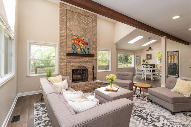 8160 W Phillips Ave, Littleton, CO 80128 - living area featuring beamed ceiling, a fireplace, wood finished floors, high vaulted ceiling, and a skylight