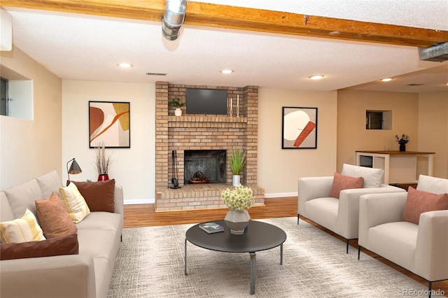 8160 W Phillips Ave, Littleton, CO 80128 - living area with a textured ceiling, wood finished floors, a fireplace, and recessed lighting