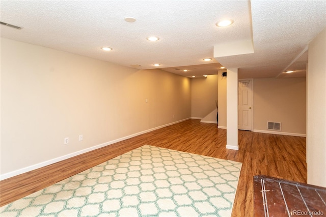 8160 W Phillips Ave, Littleton, CO 80128 - finished below grade area featuring wood finished floors, a textured ceiling, and recessed lighting