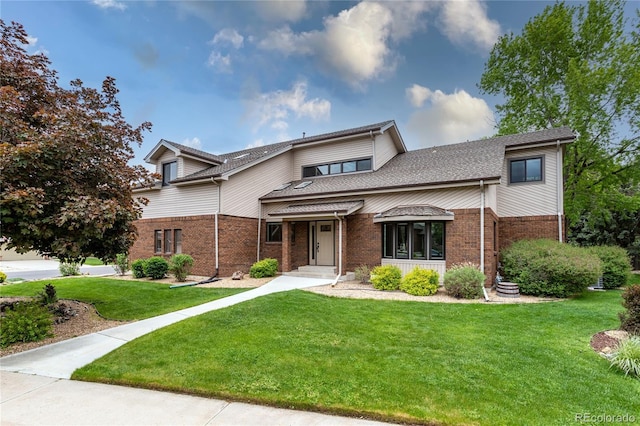 8160 W Phillips Ave, Littleton, CO 80128 - view of front facade featuring brick siding and a front lawn