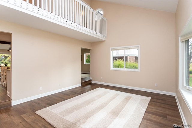 8160 W Phillips Ave, Littleton, CO 80128 - empty room featuring plenty of natural light, dark wood finished floors, and a high ceiling