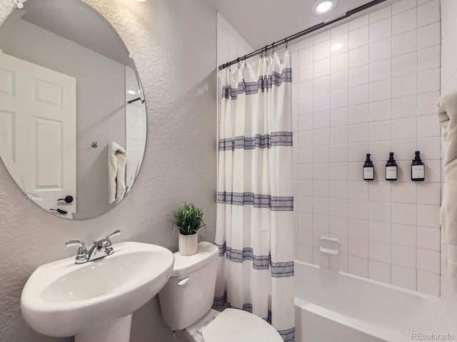 full bathroom with sink, shower / tub combo with curtain, and toilet