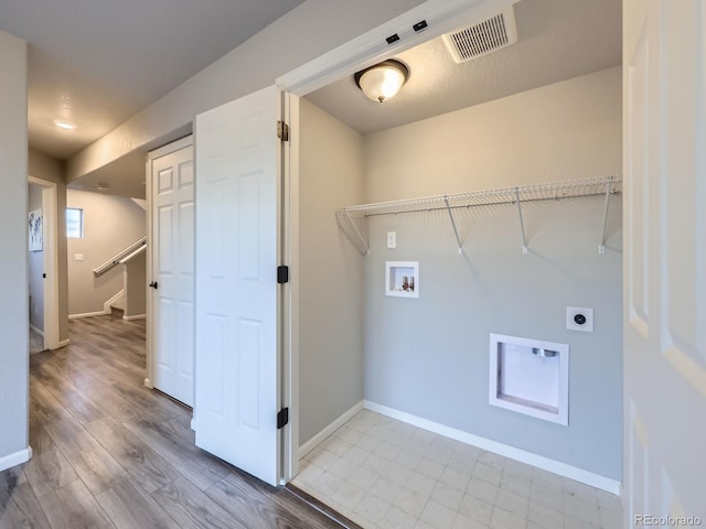 laundry area with hookup for a washing machine and hookup for an electric dryer