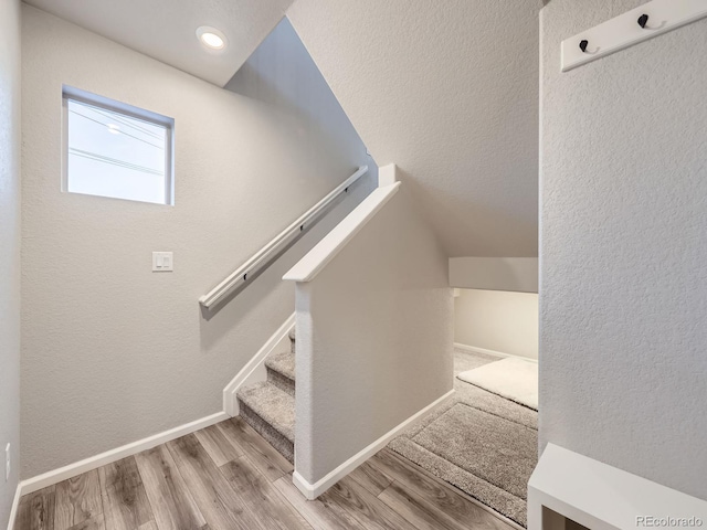 stairs with hardwood / wood-style flooring