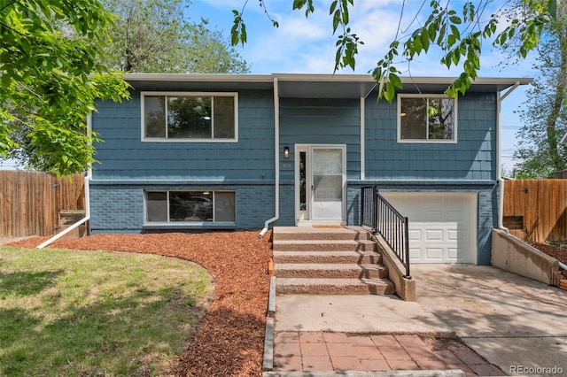 818 Don Juan Ct, Colorado Springs, CO 80909 - bi-level home featuring a garage, driveway, and brick siding