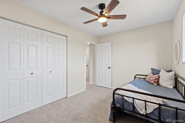 818 Don Juan Ct, Colorado Springs, CO 80909 - carpeted bedroom with a closet, baseboards, a ceiling fan, and a textured ceiling