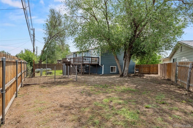 818 Don Juan Ct, Colorado Springs, CO 80909 - fenced backyard with a wooden deck and stairway