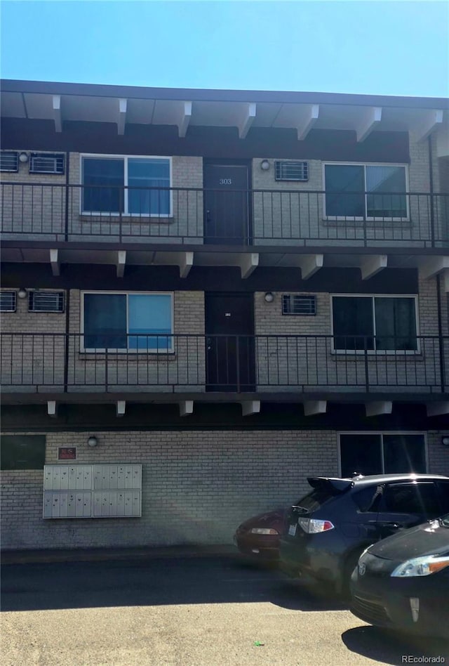 view of building exterior featuring uncovered parking