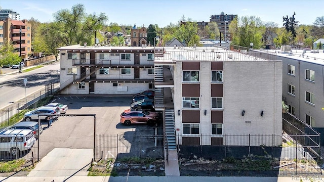 590 N Logan St Unit 303, Denver, CO 80203 - view of property with uncovered parking and fence