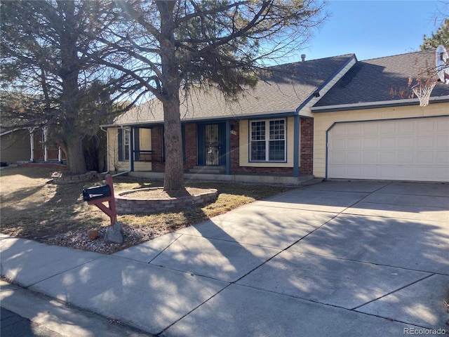 single story home with a garage, brick siding, driveway, and a shingled roof