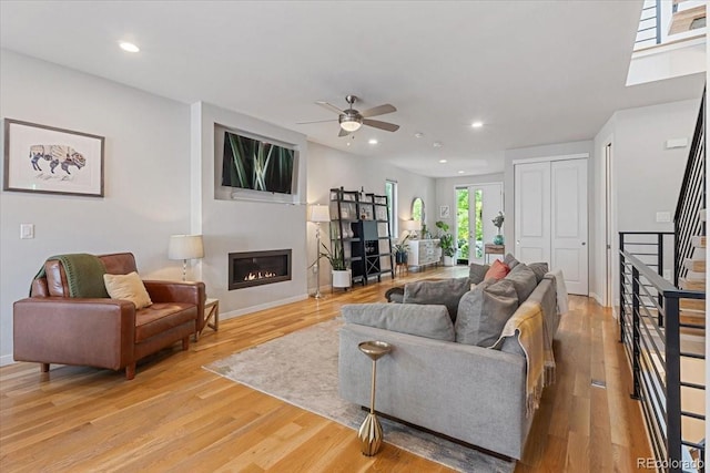 2420 S Gilpin St, Denver, CO 80210 - living area featuring stairs, ceiling fan, a glass covered fireplace, light wood finished floors, and recessed lighting