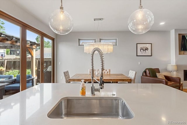 2420 S Gilpin St, Denver, CO 80210 - kitchen featuring pendant lighting, light countertops, recessed lighting, and a chandelier