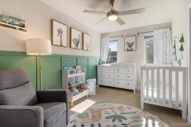 2420 S Gilpin St, Denver, CO 80210 - carpeted bedroom featuring wainscoting, a crib, and a ceiling fan