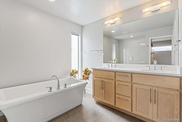 2420 S Gilpin St, Denver, CO 80210 - full bathroom with double vanity, a freestanding bath, and tile patterned floors