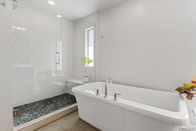 2420 S Gilpin St, Denver, CO 80210 - bathroom featuring a stall shower, a freestanding bath, and tile patterned floors