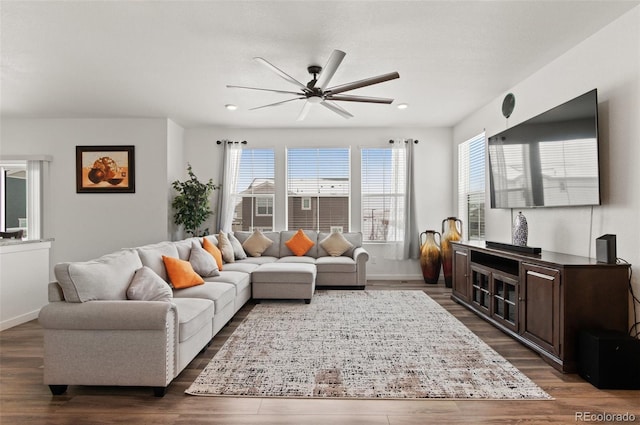 living room featuring dark hardwood / wood-style floors and ceiling fan