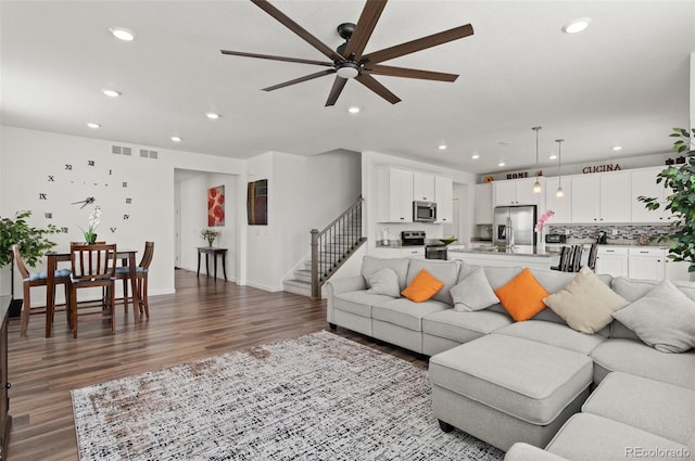 living room featuring hardwood / wood-style floors and ceiling fan