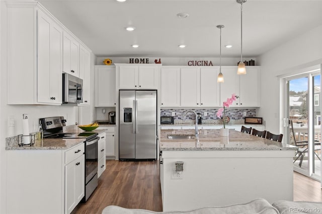 kitchen featuring sink, dark wood-type flooring, white cabinetry, hanging light fixtures, and stainless steel appliances