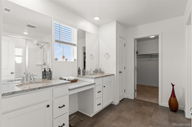 bathroom with vanity and an enclosed shower