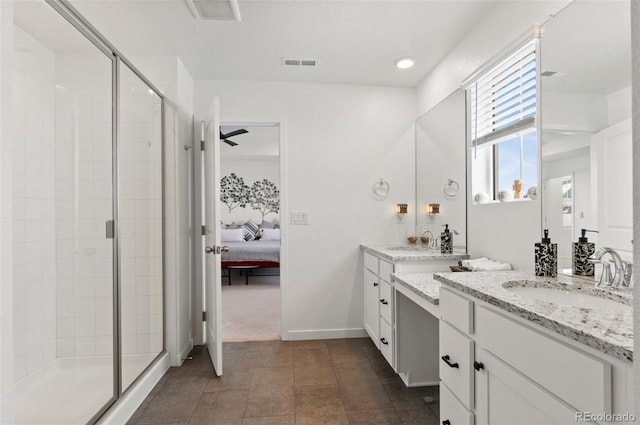 bathroom featuring vanity, a shower with shower door, and tile patterned floors