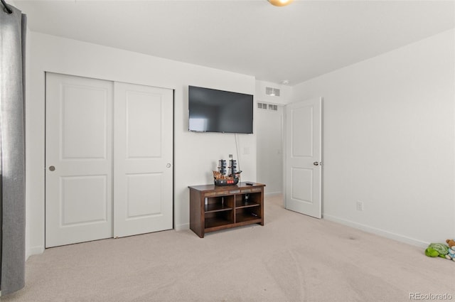 carpeted bedroom featuring a closet