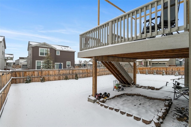 snowy yard featuring a deck