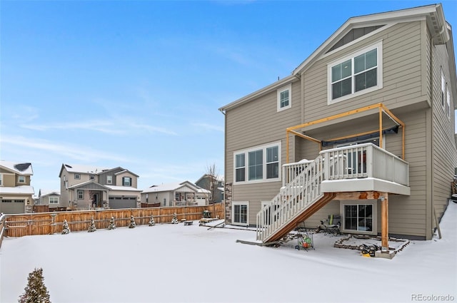 snow covered property featuring a wooden deck