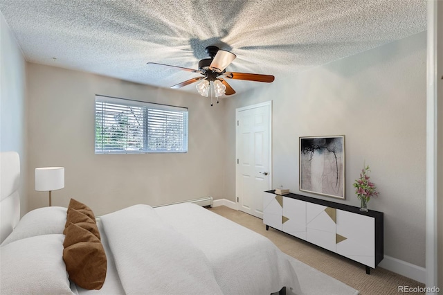 4812 W 8th Ave, Denver, CO 80204 - bedroom featuring light colored carpet, a baseboard heating unit, a textured ceiling, and a ceiling fan