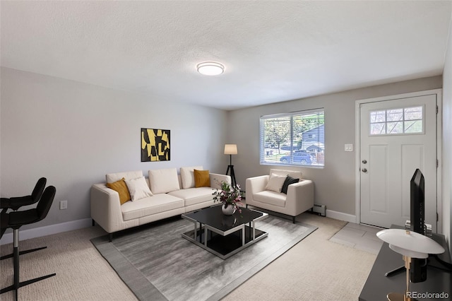 4812 W 8th Ave, Denver, CO 80204 - living area with baseboard heating, light colored carpet, and a textured ceiling
