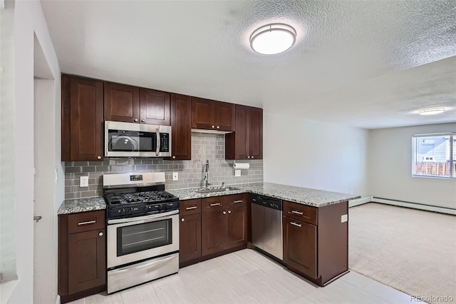 4812 W 8th Ave, Denver, CO 80204 - kitchen featuring appliances with stainless steel finishes, a peninsula, light stone counters, backsplash, and dark brown cabinets