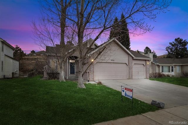 view of front of home featuring a yard and a garage