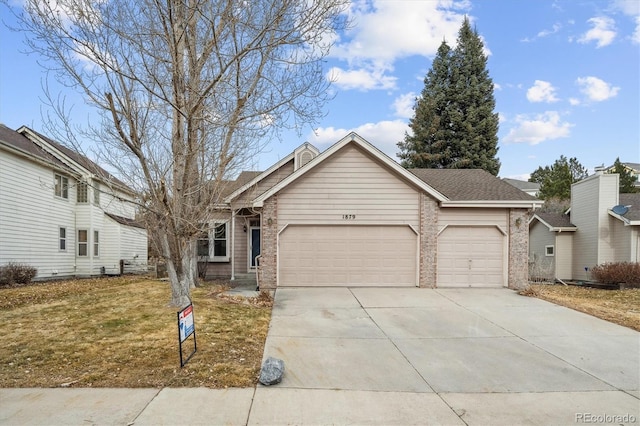 view of front of home featuring a garage and a front lawn