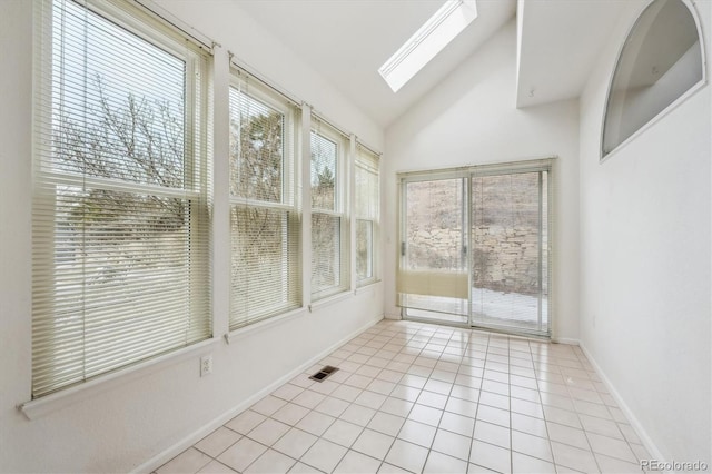 unfurnished sunroom featuring vaulted ceiling with skylight