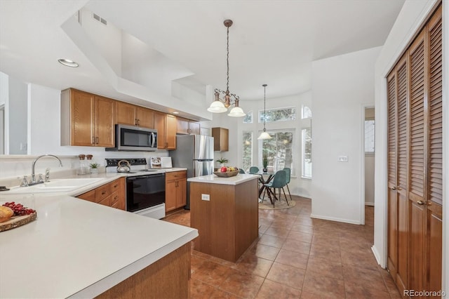 kitchen featuring pendant lighting, sink, appliances with stainless steel finishes, a center island, and light tile patterned flooring