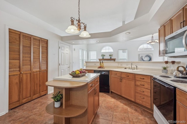 kitchen with pendant lighting, dishwasher, sink, a center island, and electric stove