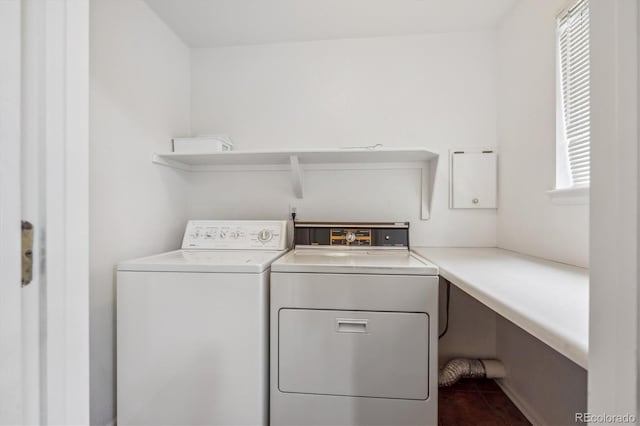 clothes washing area featuring washer and clothes dryer