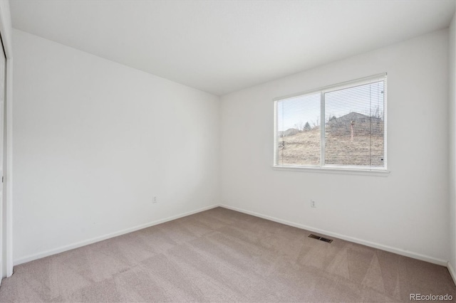 empty room featuring light carpet