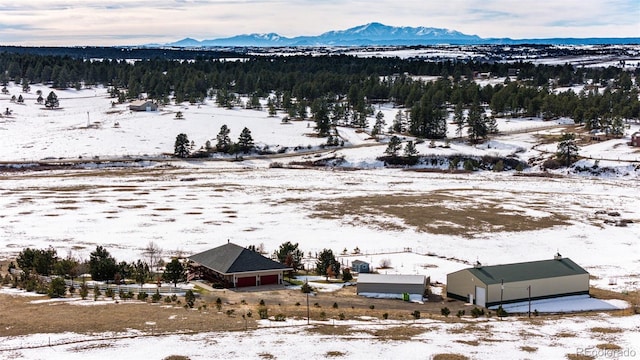 snowy aerial view featuring a mountain view