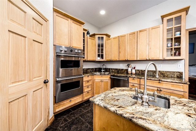 kitchen featuring light stone countertops, light brown cabinets, sink, and appliances with stainless steel finishes