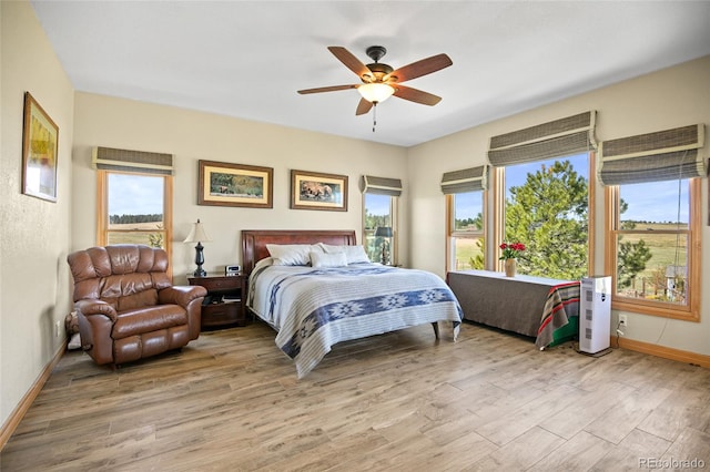 bedroom with light hardwood / wood-style floors and ceiling fan